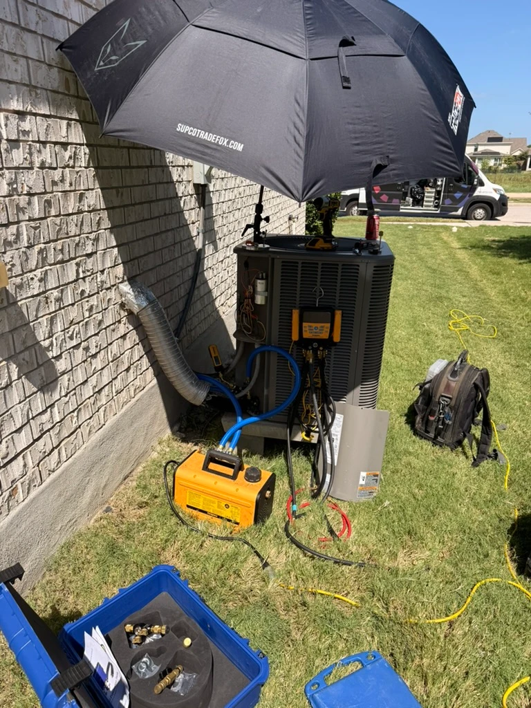 HVAC services Pflugerville TX, featuring an air conditioning unit under maintenance with tools and equipment nearby.