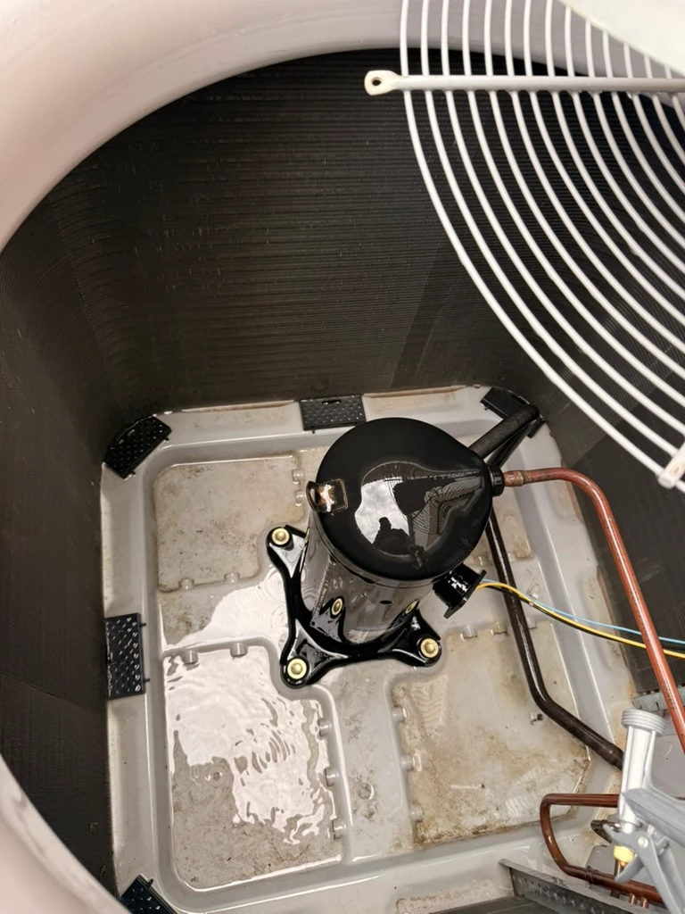 HVAC system components in Pflugerville, TX, showcasing a sump pump and drainage setup for efficient cooling.